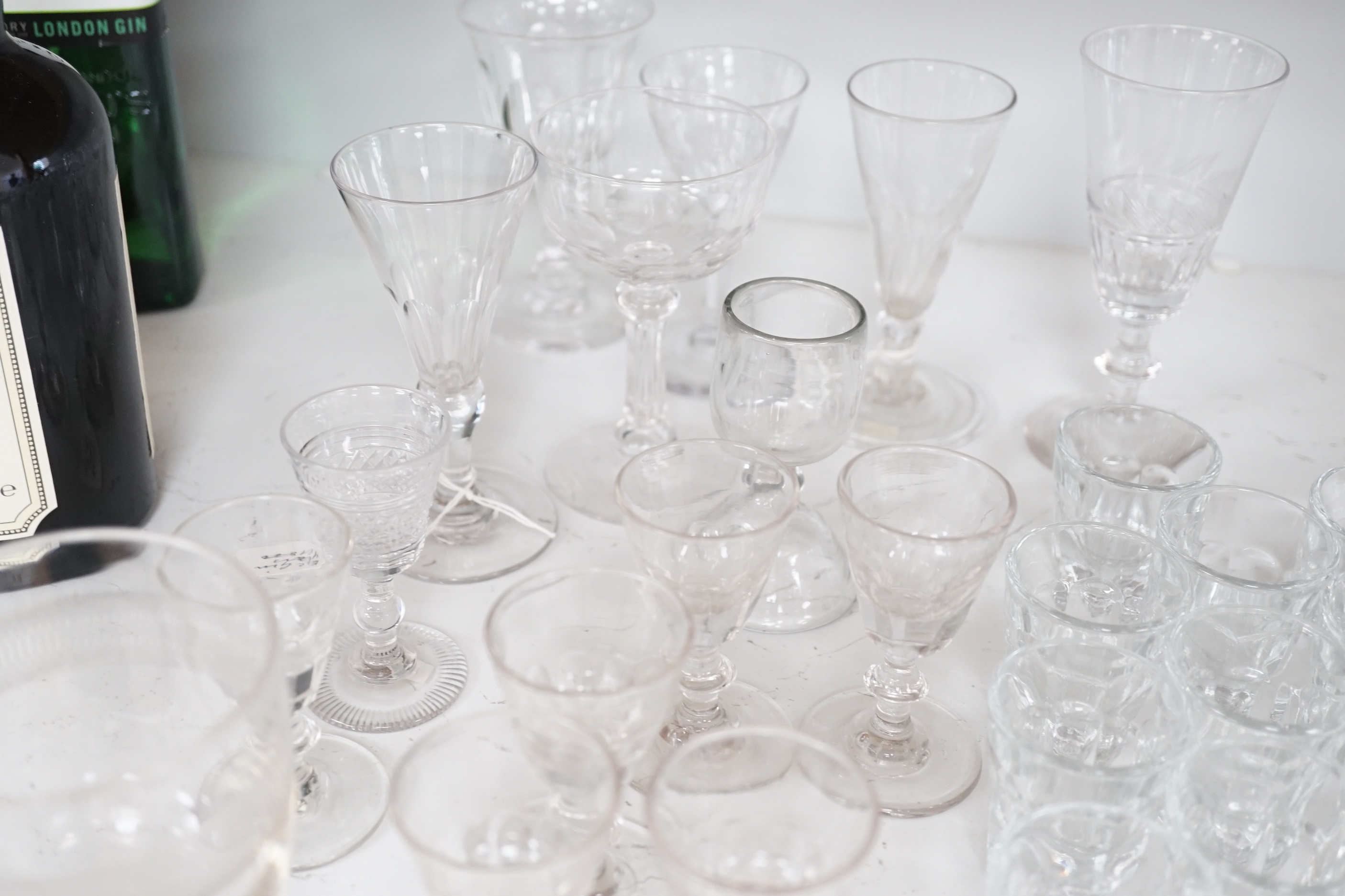A collection of early 19th to early 20th century drinking glasses, including a set of twelve shot glasses, a set of six liqueur glasses, plus nine other wine, gin and sherry glasses of various sizes, tallest 14.5cm (27)